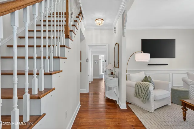 a hallway with a couch and a flat screen tv