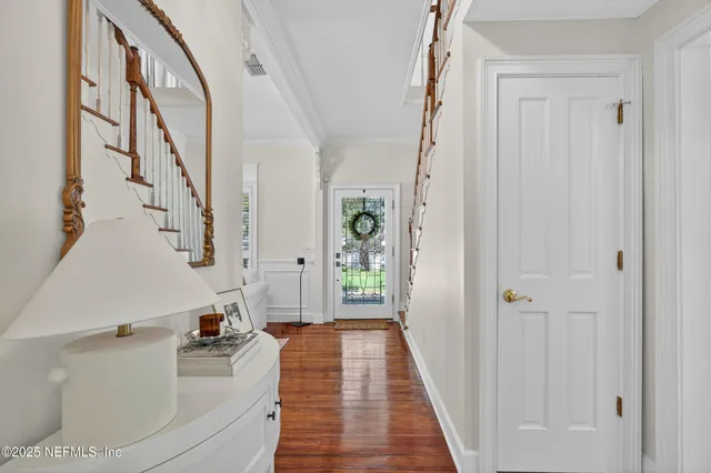 a very nice looking room with wooden floor and stairs