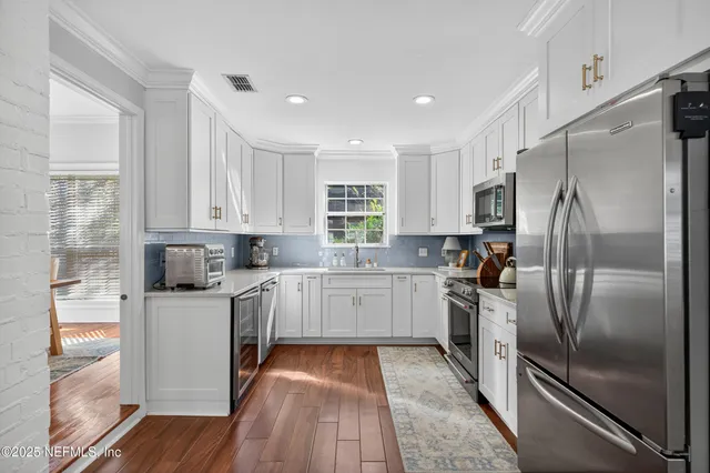 a kitchen with a refrigerator a sink and dishwasher