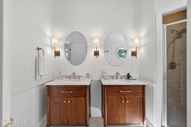 a bathroom with 2 sink and a mirror