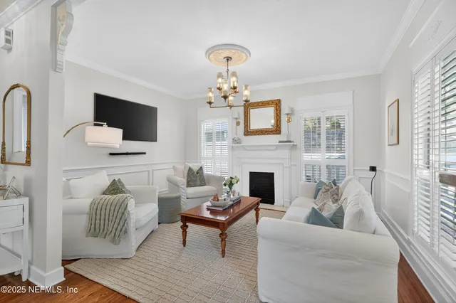 a living room with furniture a fireplace and a flat screen tv