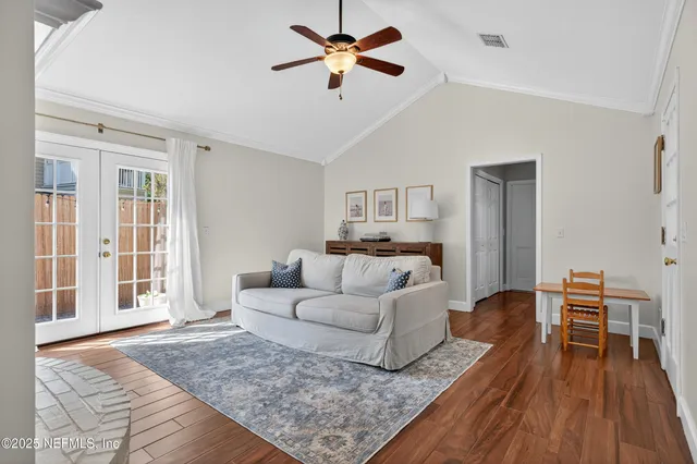 a living room with furniture and a wooden floor