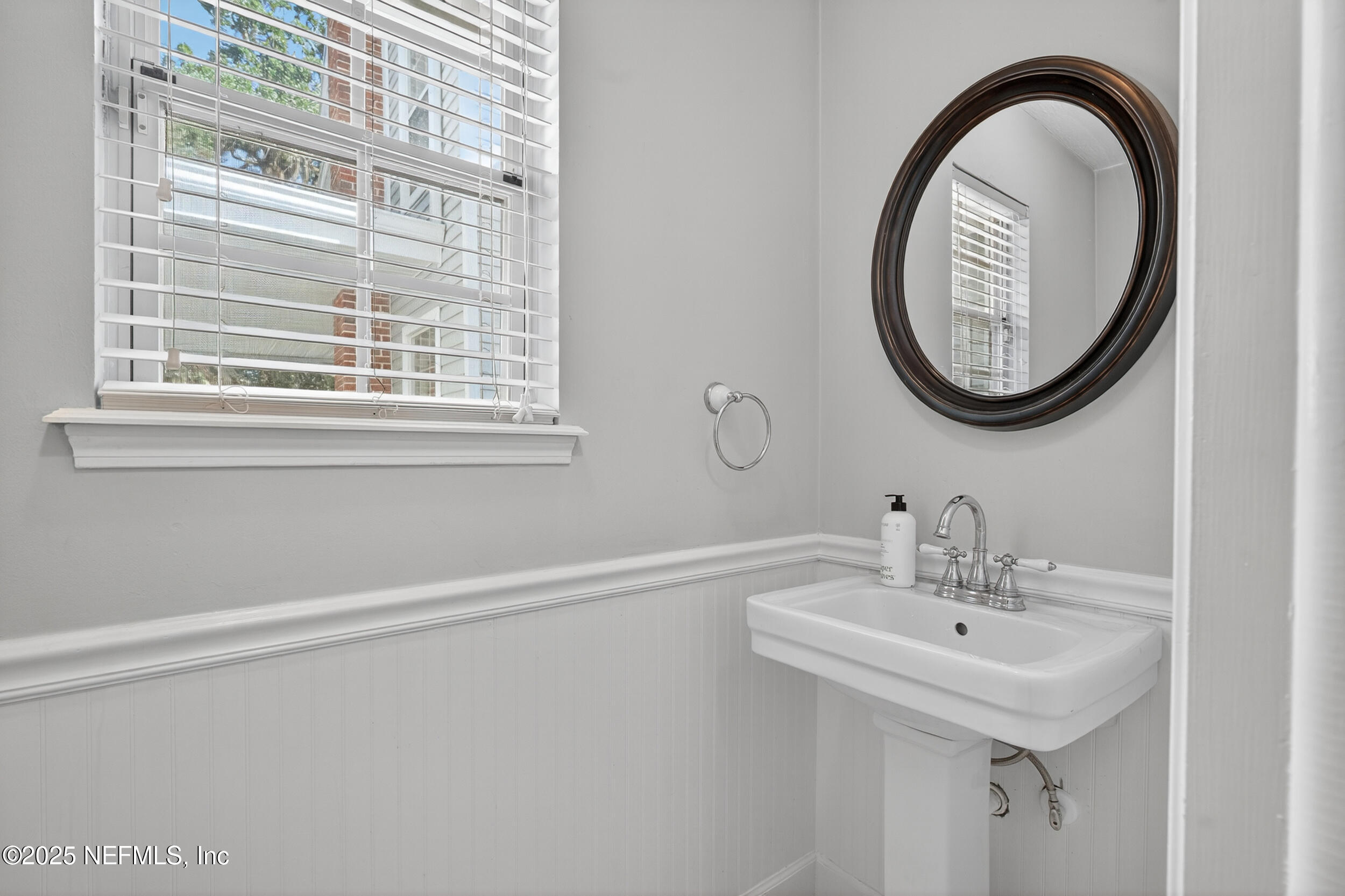 2734 Loretto Road Jacksonville, FL 32223 - Photo 24 of 35 a bathroom with a sink and a mirror