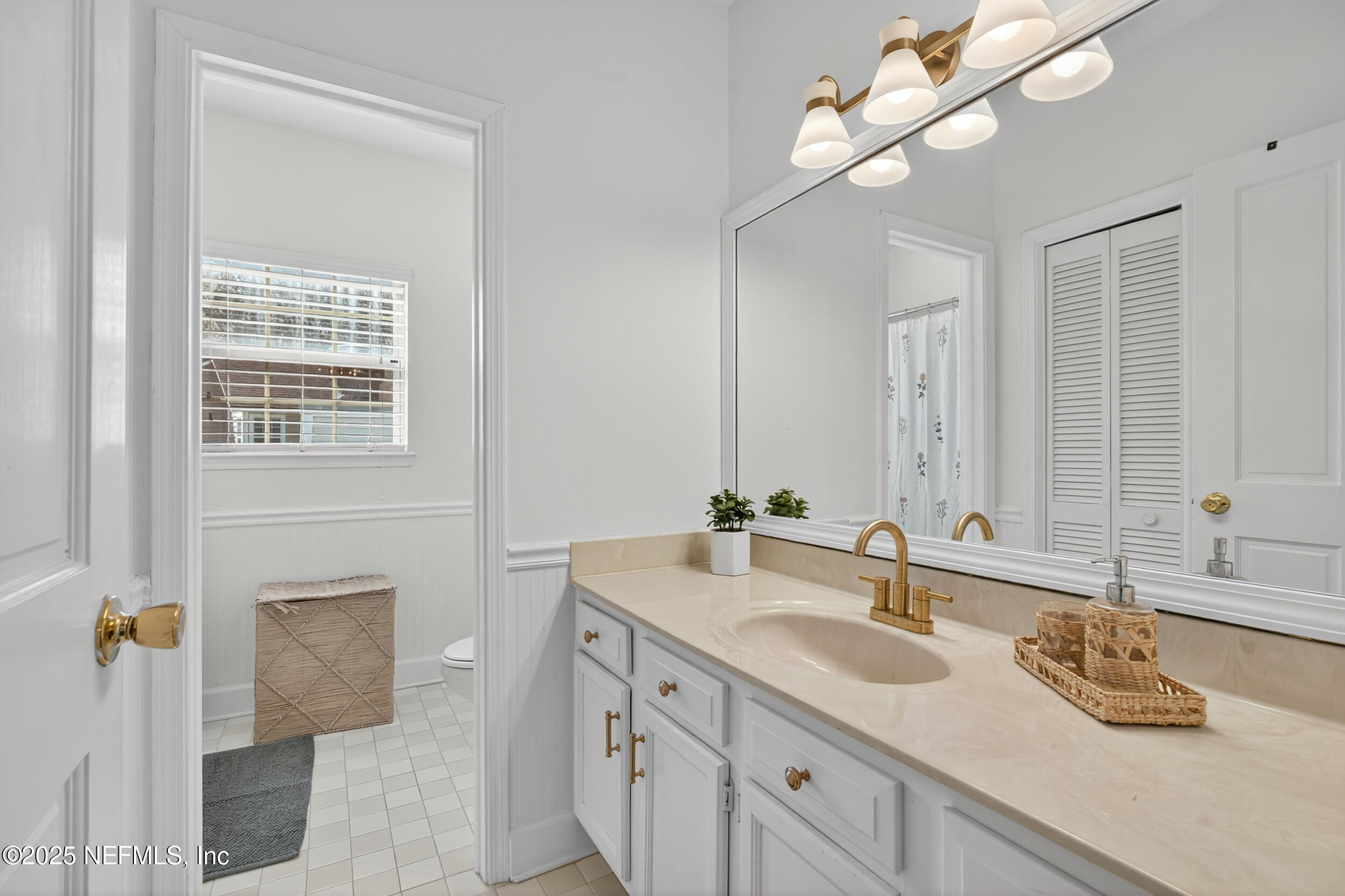 2734 Loretto Road Jacksonville, FL 32223 - Photo 27 of 35 a bathroom with a granite countertop double vanity sink and a mirror