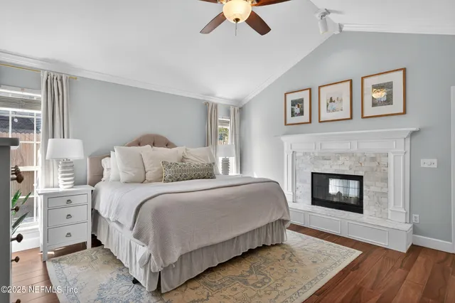 a spacious bedroom with a bed and a fireplace