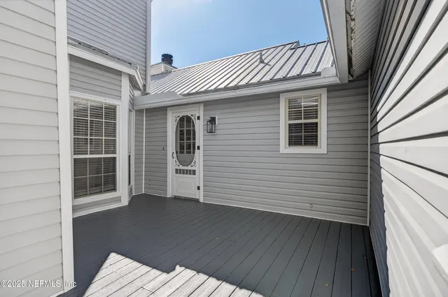 a view of a house with wooden deck