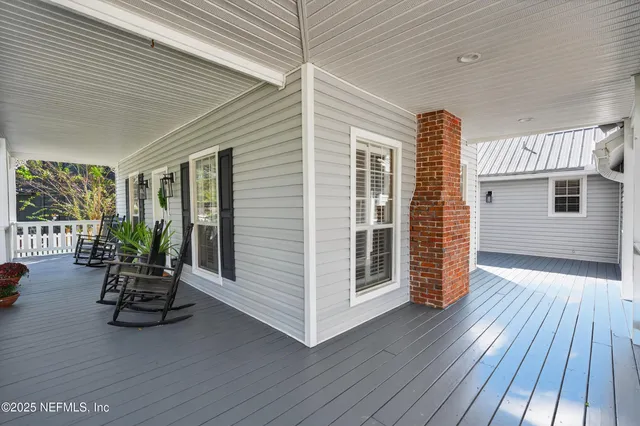 a view of a patio with table and chairs and wooden floor