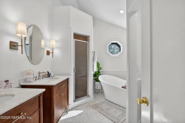 a spacious bathroom with a granite countertop tub sink and mirror