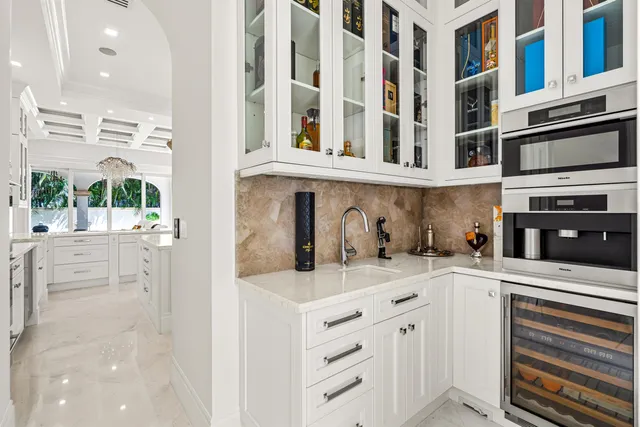 a kitchen with a sink cabinets and appliances
