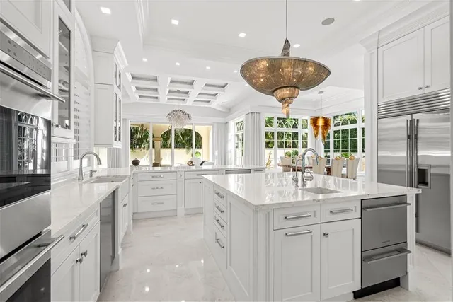 a large kitchen with stainless steel appliances kitchen island granite countertop a sink and cabinets