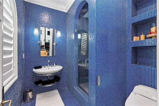 a bathroom with a toilet a sink and mirror