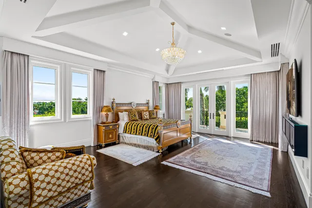 a bedroom with furniture and a large window