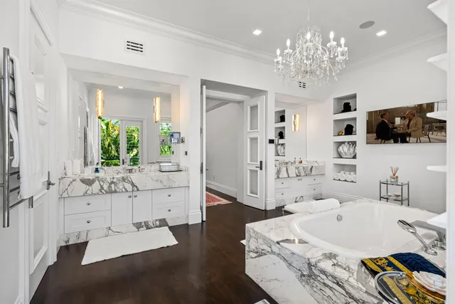 a spacious bedroom with furniture and a flat screen tv