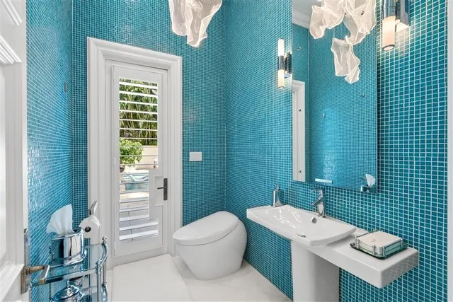 a bathroom with a toilet a sink and shower