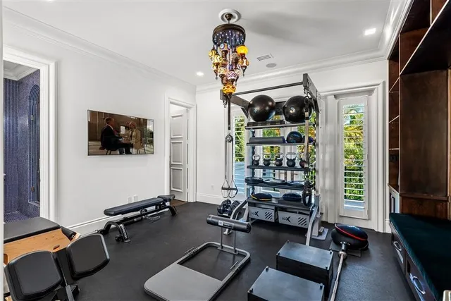 a room with gym equipment and a flat screen tv