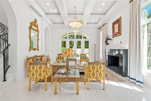 a view of a dining room with furniture chandelier and a fireplace