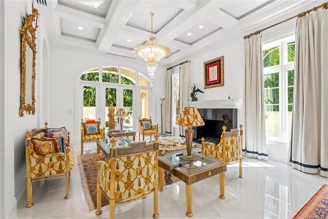 a living room with fireplace furniture and a large window