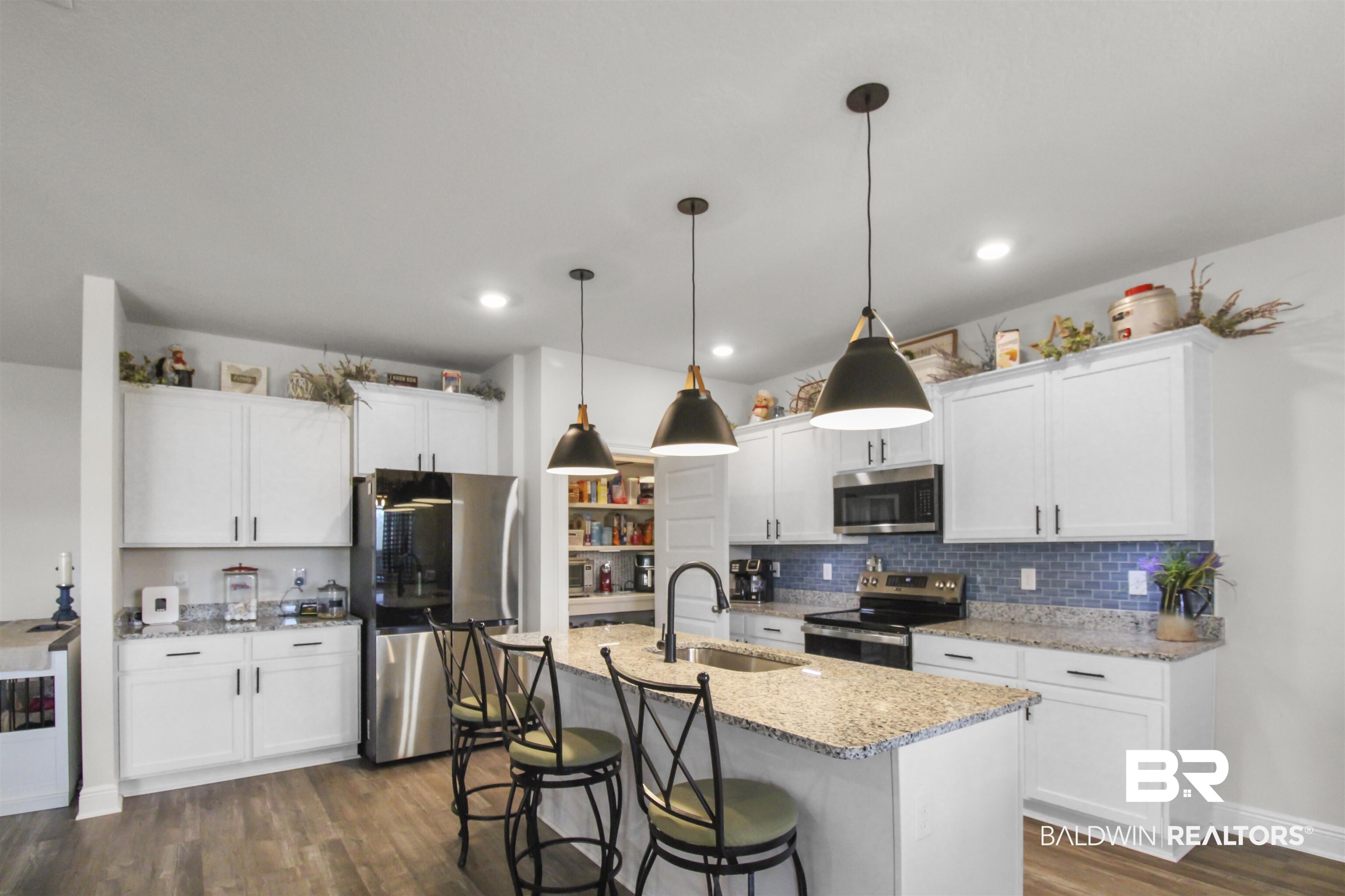 12523 Pheasant Run Elberta, AL 36530 - Photo 9 of 43 Kitchen featuring white cabinets, stainless steel appliances, light stone countertops, pendant lighting, and dark wood-style floors