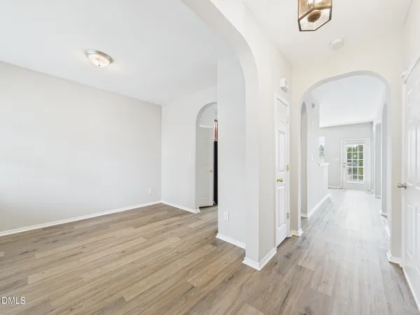 a view of a kitchen with wooden floor and a hallway