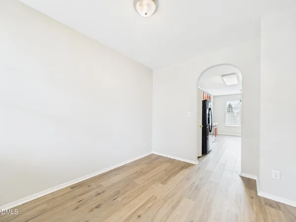 a kitchen with a stove and a wooden floor