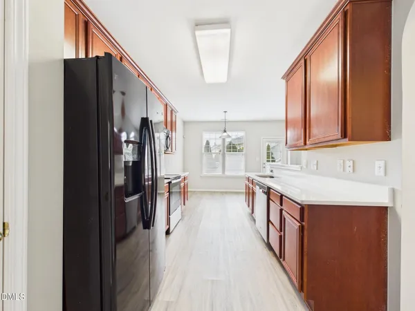 a kitchen with stainless steel appliances granite countertop a refrigerator stove top oven and sink