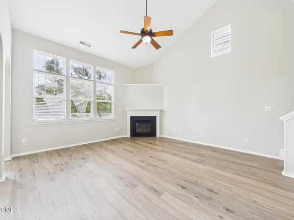 a view of a room with a ceiling fan and a window