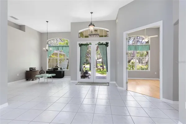 a very nice looking room with a large window and chandelier