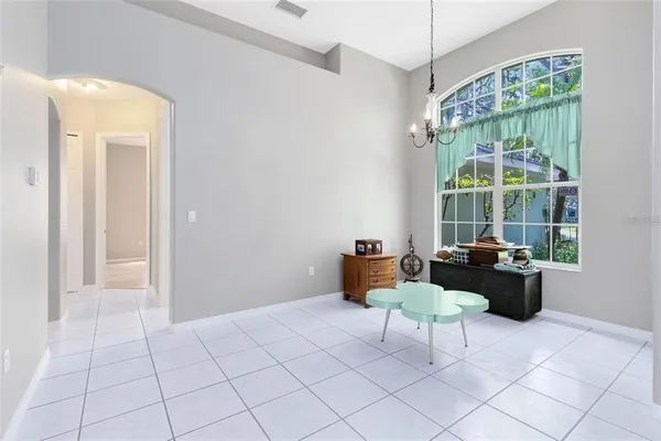 a kitchen with stainless steel appliances granite countertop a stove a sink a microwave a dining table and chairs