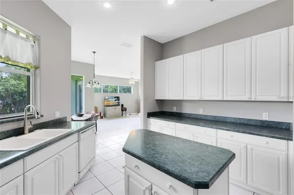 a kitchen with stainless steel appliances a stove a sink a microwave a refrigerator and cabinets