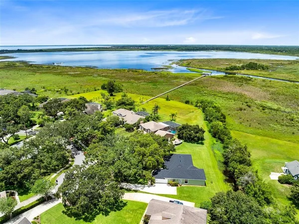 an aerial view of residential houses with yard