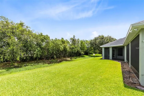 a view of a house with a yard and tree