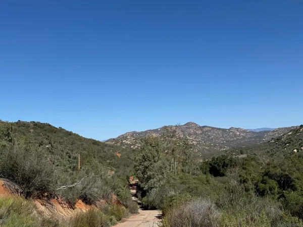 a view of a mountain range in a cloudy sky