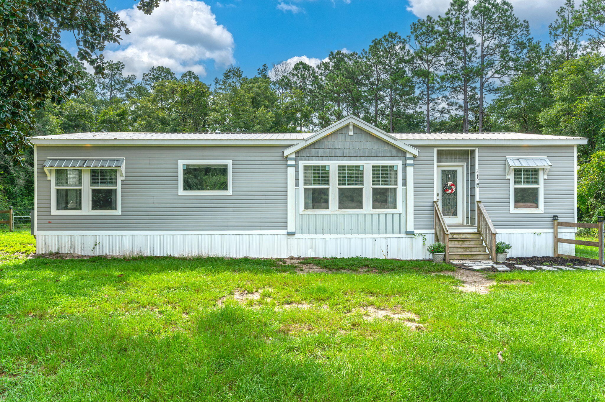 5979 Old River Road Baker, FL 32531 - Photo 1 of 46 a view of a house with a yard