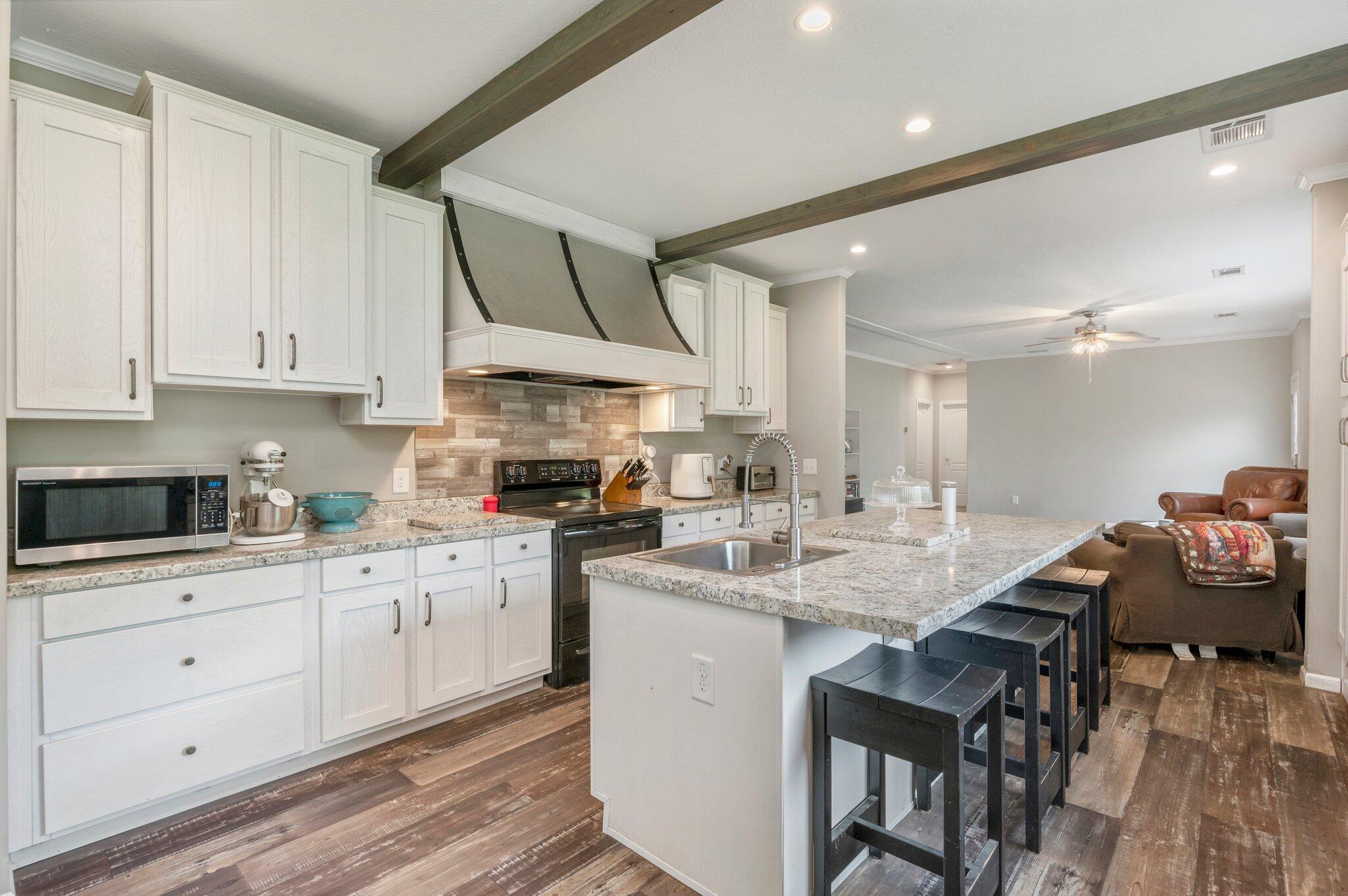 5979 Old River Road Baker, FL 32531 - Photo 11 of 46 a kitchen with granite countertop a sink cabinets and window