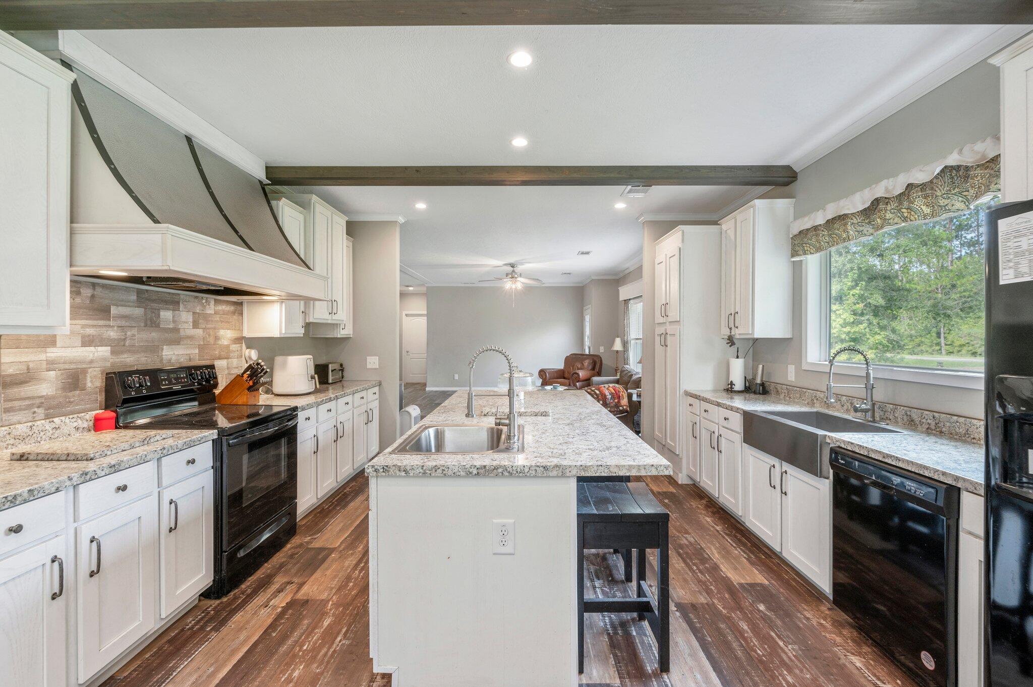 5979 Old River Road Baker, FL 32531 - Photo 14 of 46 a open kitchen with stainless steel appliances granite countertop a sink and cabinets