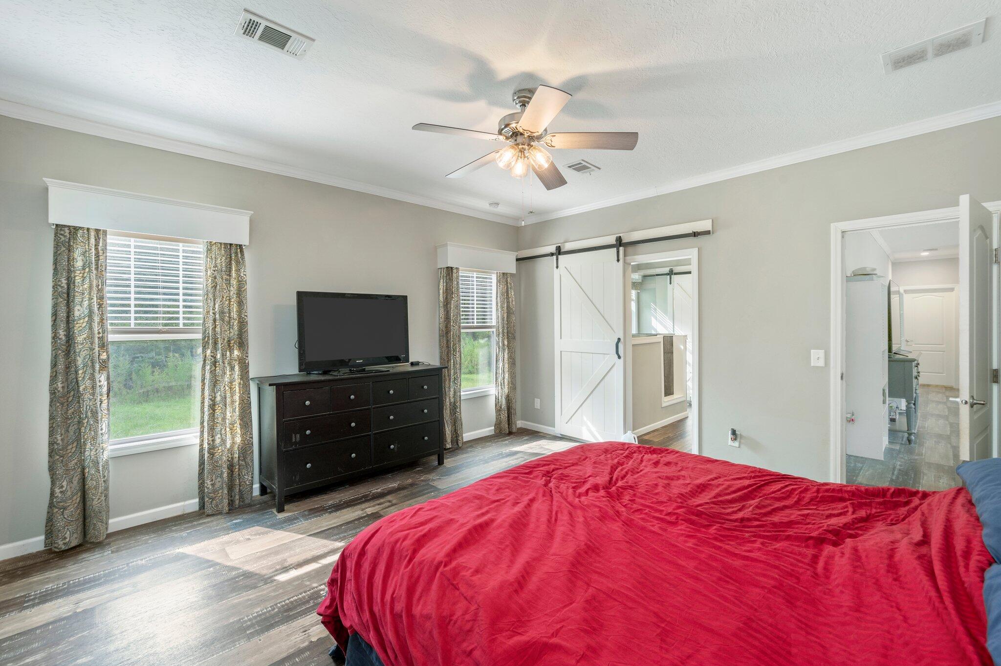 5979 Old River Road Baker, FL 32531 - Photo 19 of 46 a bedroom with a bed and a flat screen tv