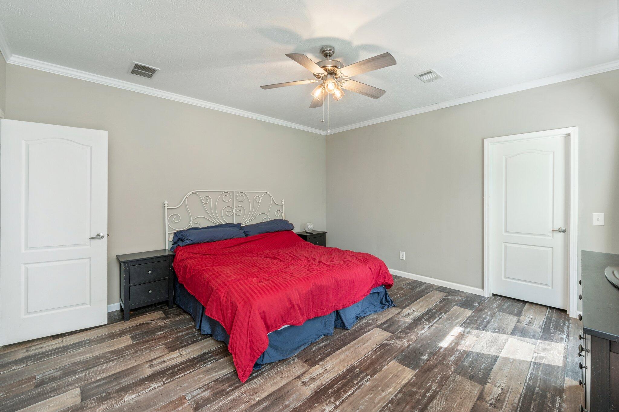 5979 Old River Road Baker, FL 32531 - Photo 20 of 46 a bedroom with a bed and a chandelier