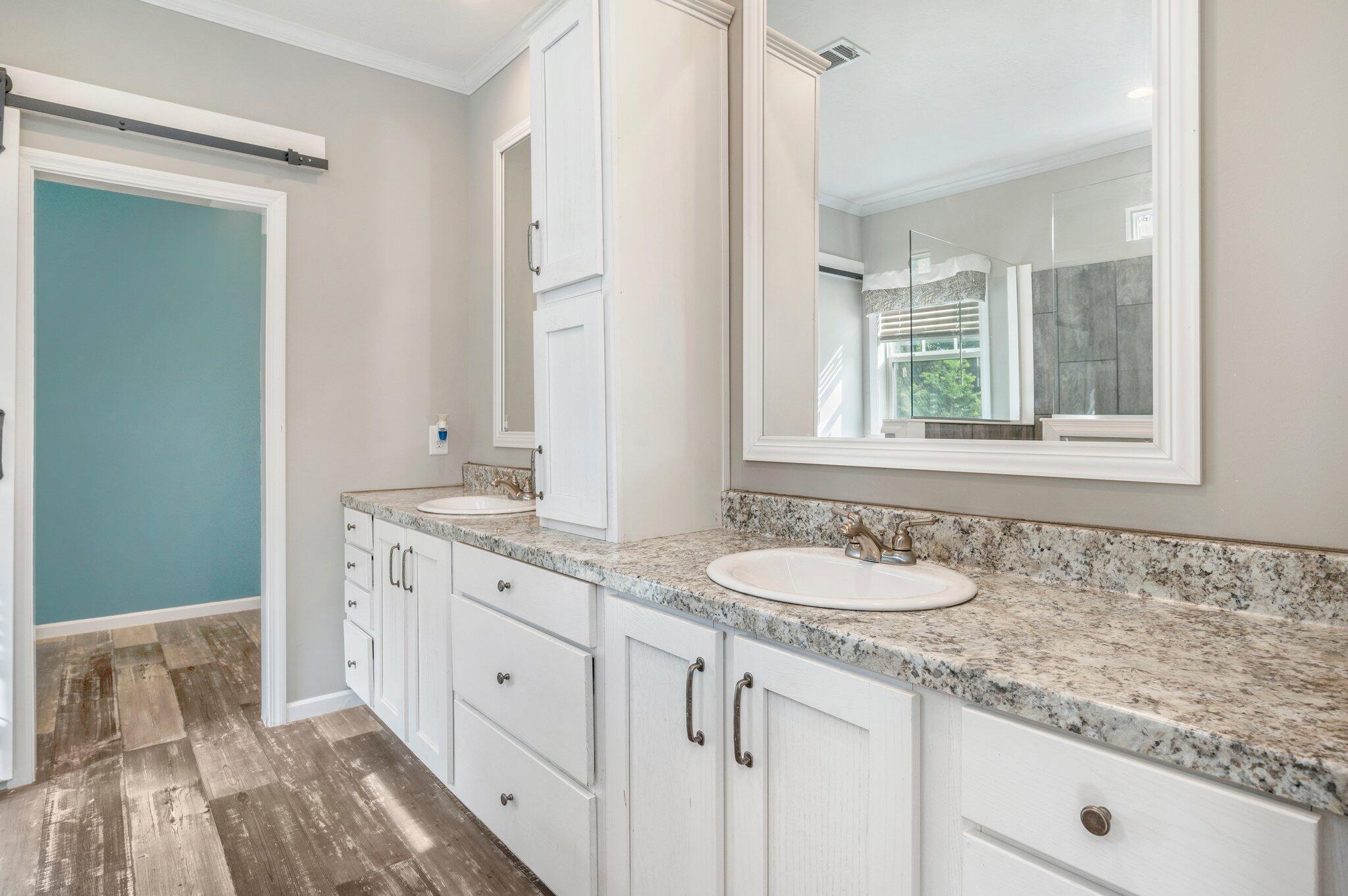 5979 Old River Road Baker, FL 32531 - Photo 21 of 46 a bathroom with a granite countertop sink and a mirror