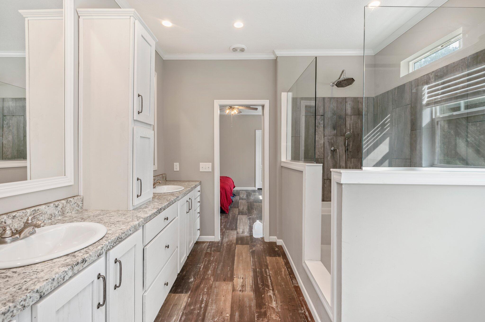 5979 Old River Road Baker, FL 32531 - Photo 26 of 46 a bathroom with a double vanity sink and mirror