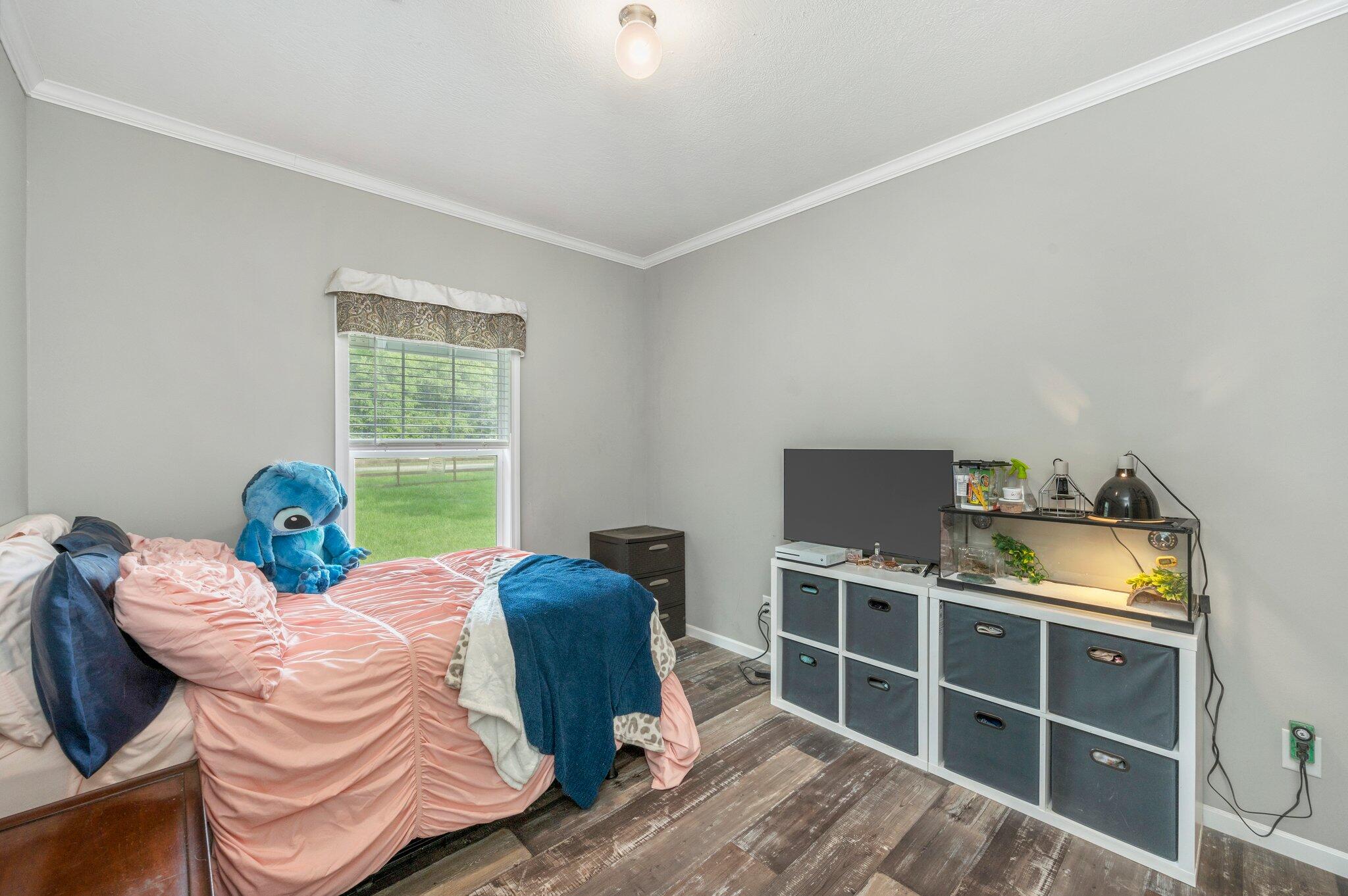 5979 Old River Road Baker, FL 32531 - Photo 27 of 46 a bed room with furniture and a window