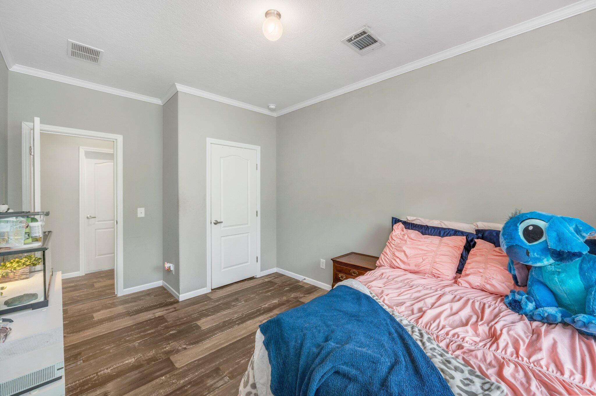 5979 Old River Road Baker, FL 32531 - Photo 28 of 46 a bedroom with a bed and wooden floor