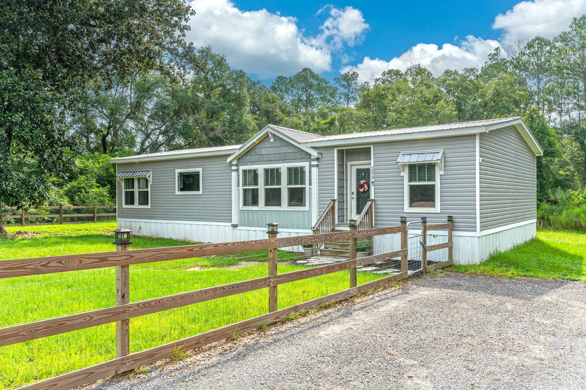 5979 Old River Road Baker, FL 32531 - Photo 3 of 46 a view of a house with swimming pool and a yard