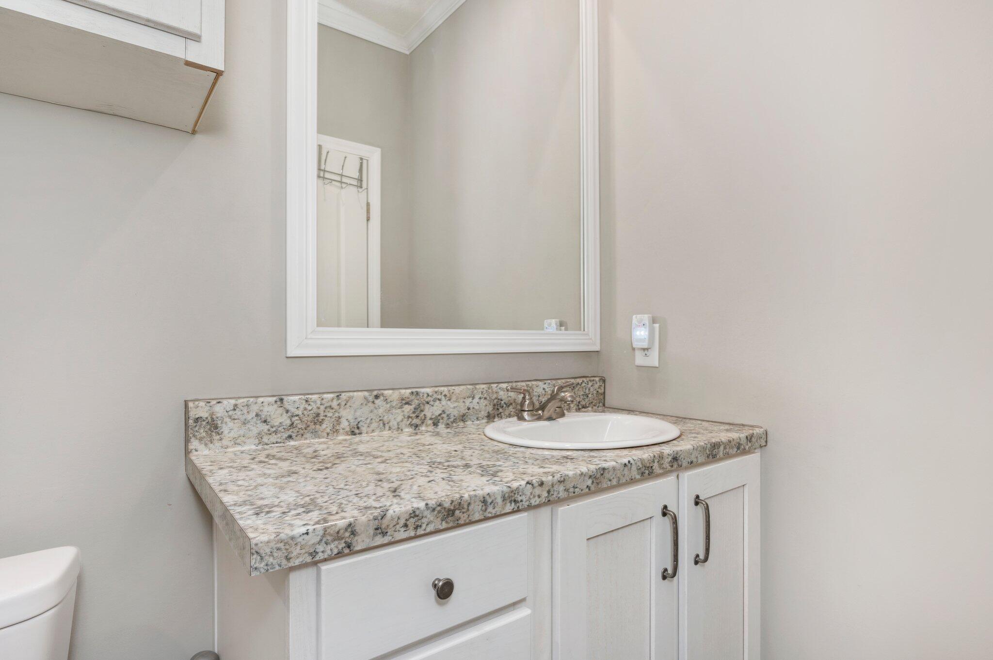5979 Old River Road Baker, FL 32531 - Photo 31 of 46 a bathroom with a granite countertop sink and a mirror
