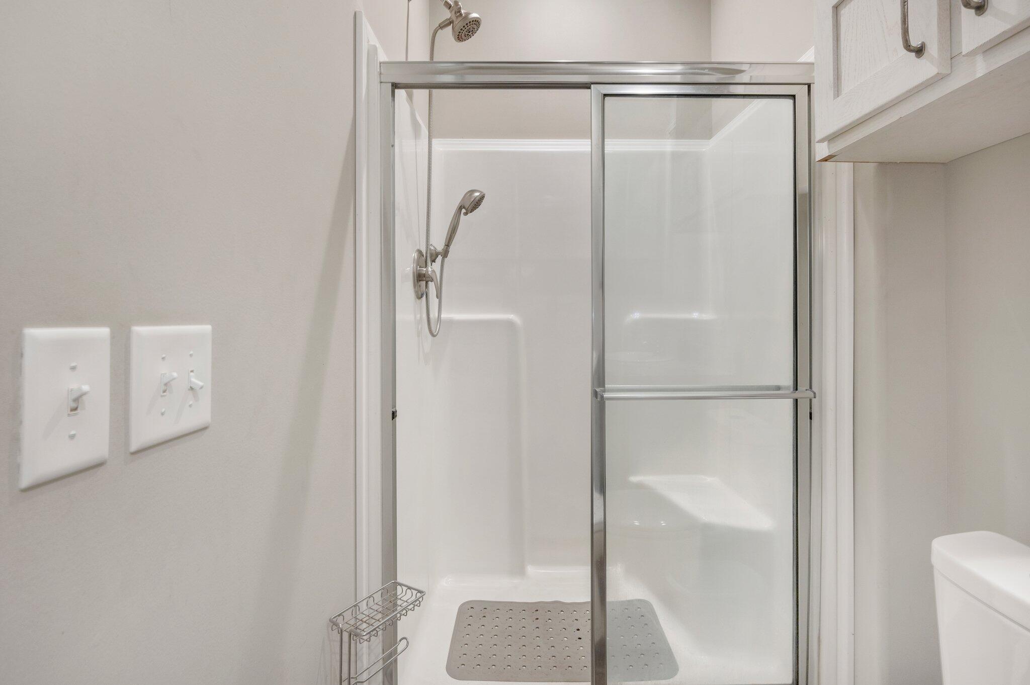 5979 Old River Road Baker, FL 32531 - Photo 32 of 46 a bathroom with a glass shower door