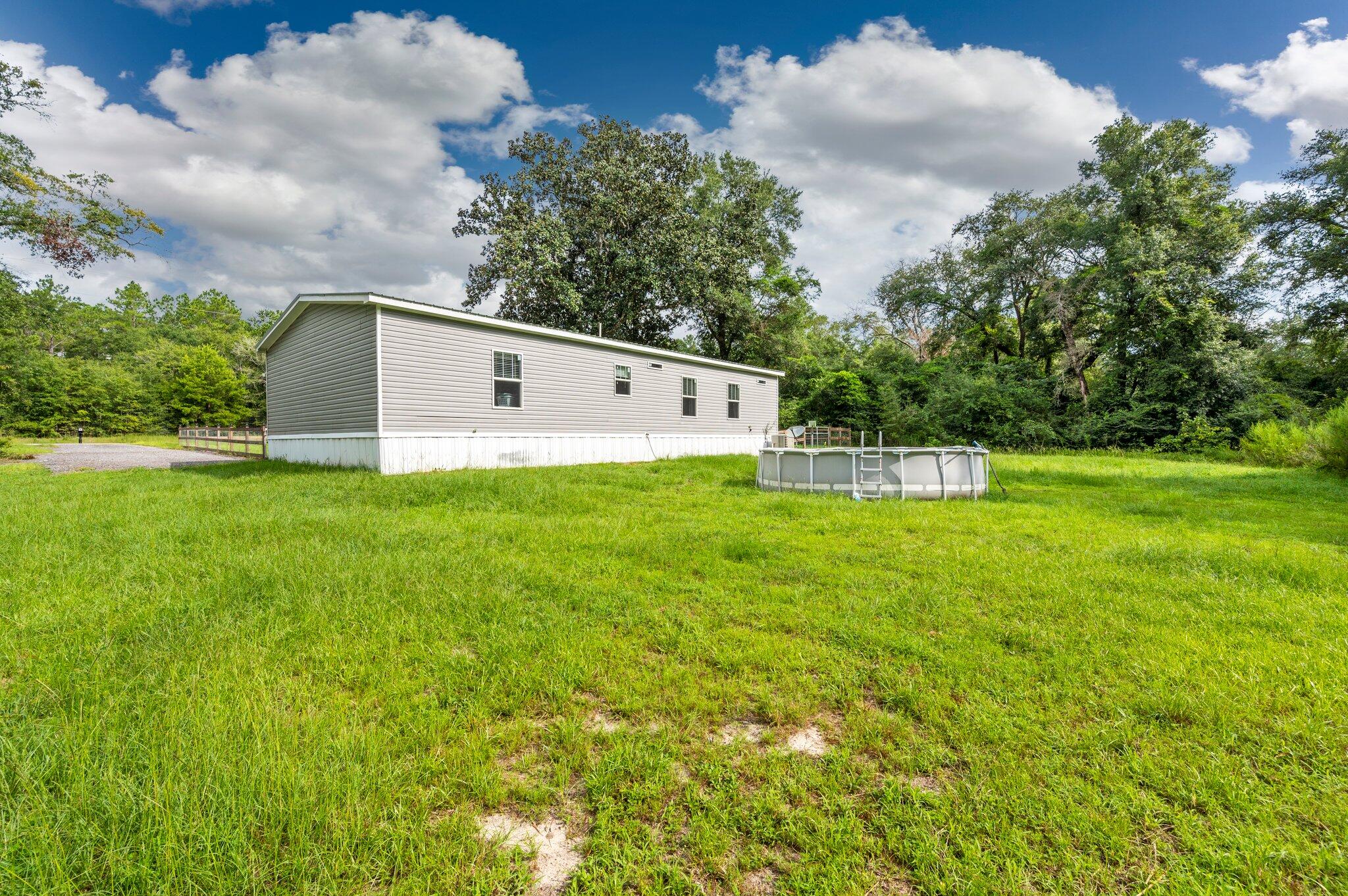5979 Old River Road Baker, FL 32531 - Photo 37 of 46 a front view of a house with garden