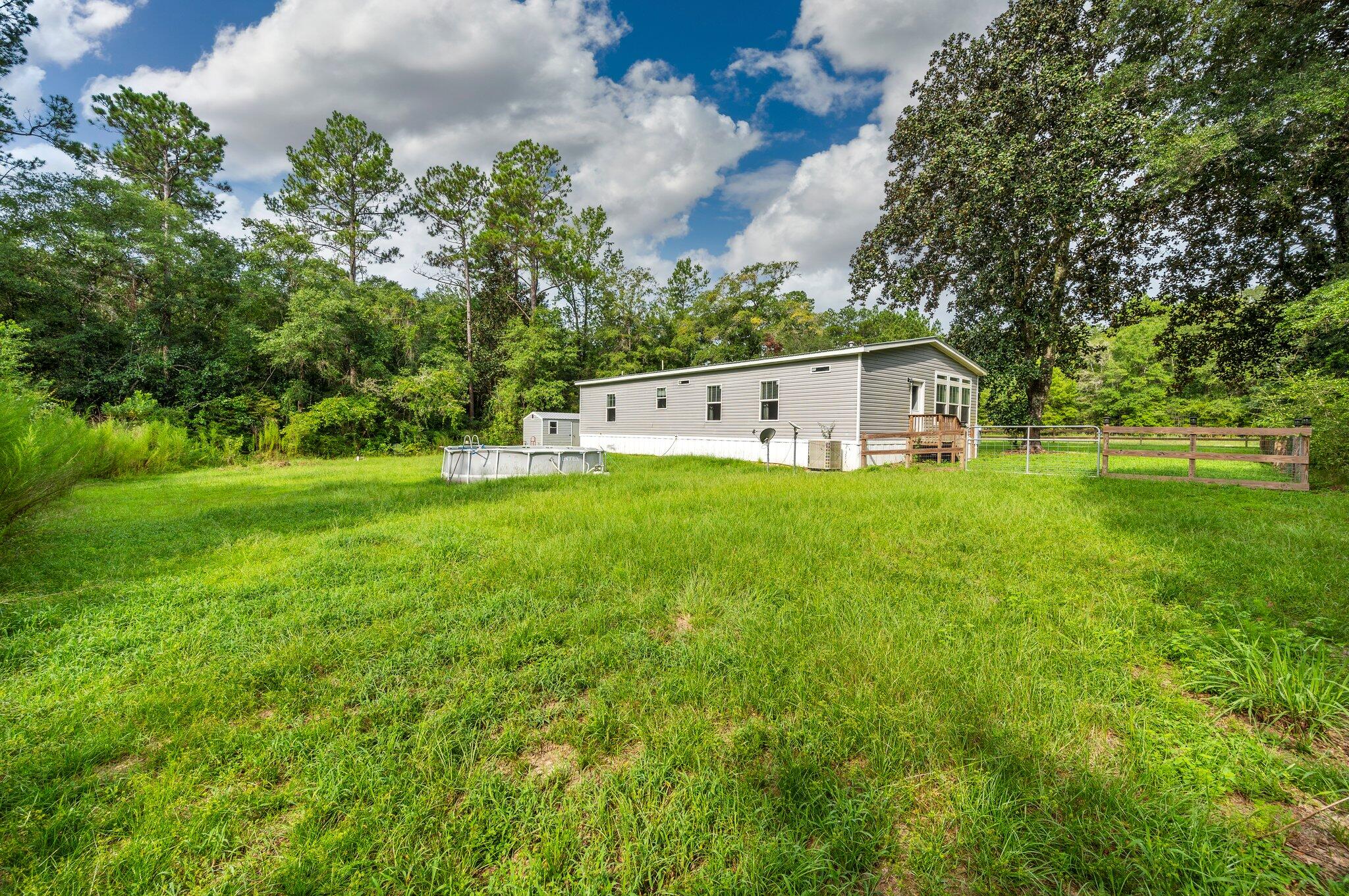 5979 Old River Road Baker, FL 32531 - Photo 38 of 46 a view of a house with a big yard