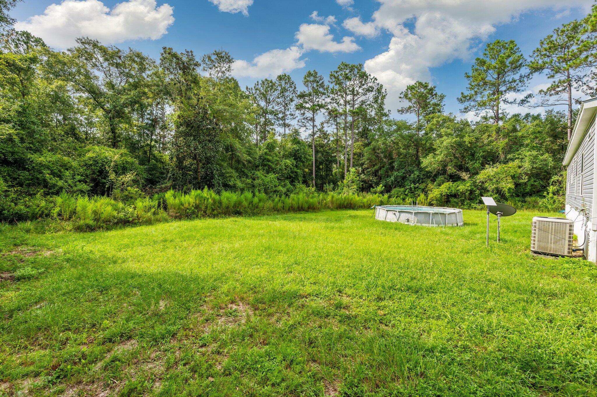 5979 Old River Road Baker, FL 32531 - Photo 39 of 46 a view of a house with a yard