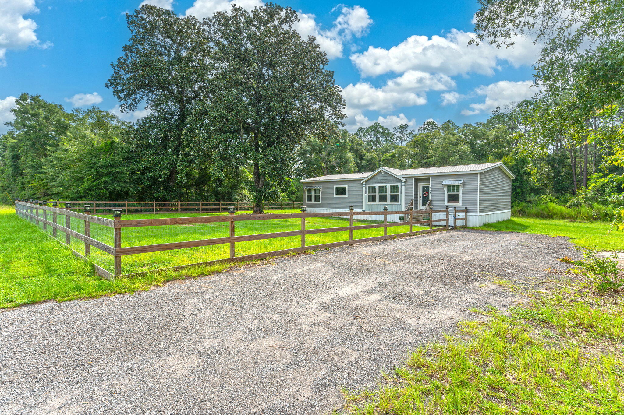 5979 Old River Road Baker, FL 32531 - Photo 4 of 46 a view of a house with swimming pool and a yard