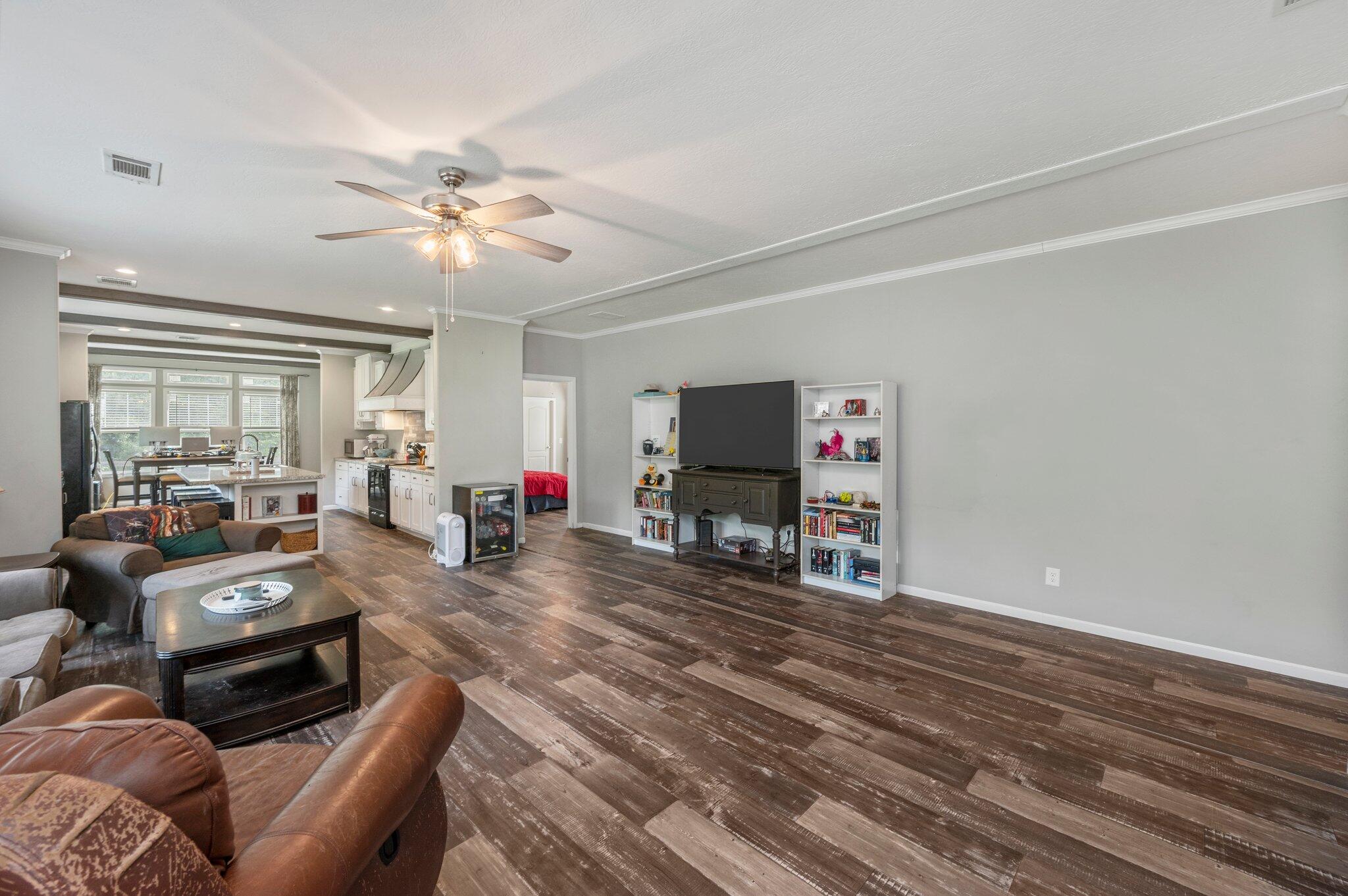5979 Old River Road Baker, FL 32531 - Photo 5 of 46 a living room with furniture a flat screen tv and wooden floor