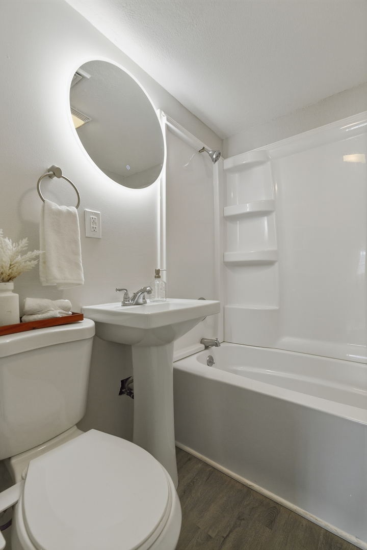 2306 9th Street Silvis, IL 61282 - Photo 26 of 32 a bathroom with a sink mirror vanity and toilet